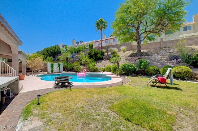 view of swimming pool with a fenced backyard, a lawn, and a patio