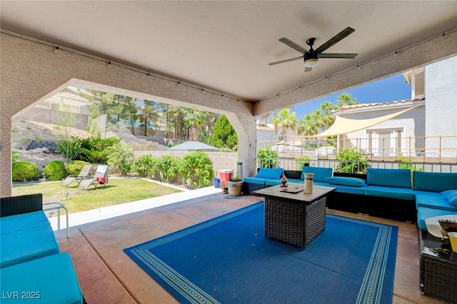 view of patio with an outdoor hangout area, fence, and a ceiling fan