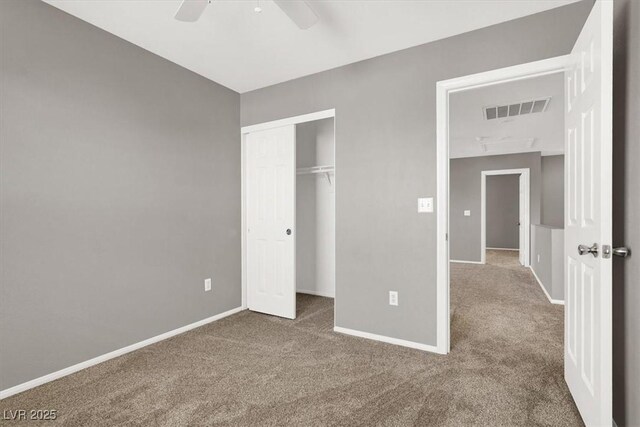 unfurnished bedroom featuring a closet, carpet, visible vents, and baseboards