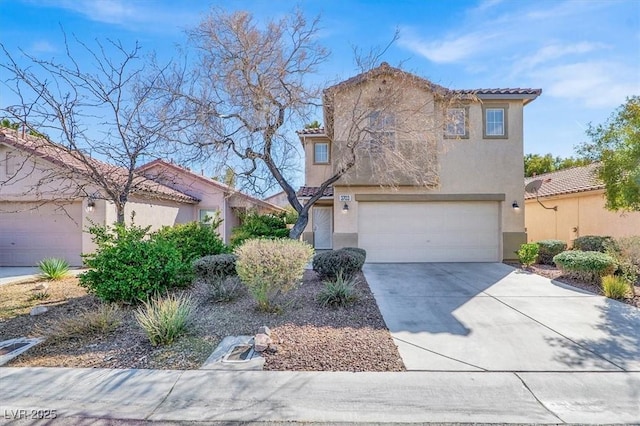 mediterranean / spanish-style home featuring a garage, concrete driveway, a tiled roof, and stucco siding