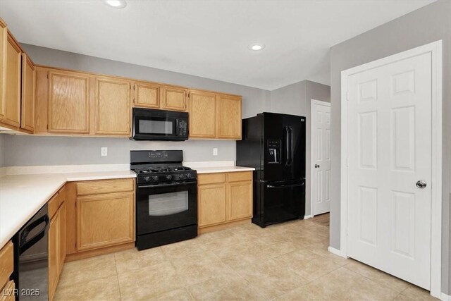 kitchen featuring black appliances, light countertops, built in desk, and recessed lighting