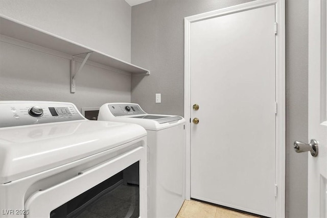 laundry room with light tile patterned floors, laundry area, and washer and dryer