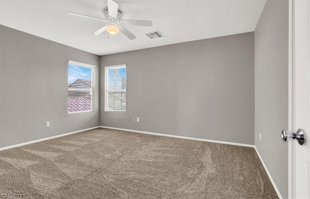 empty room featuring ceiling fan, carpet, visible vents, and baseboards