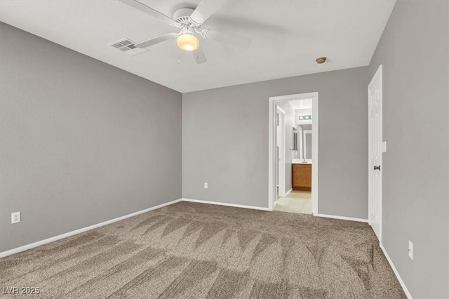 empty room with carpet floors, visible vents, baseboards, and a ceiling fan