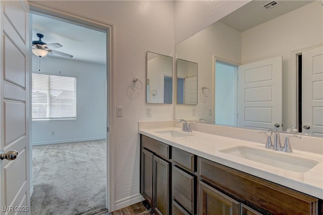 full bath with double vanity, ceiling fan, visible vents, and a sink