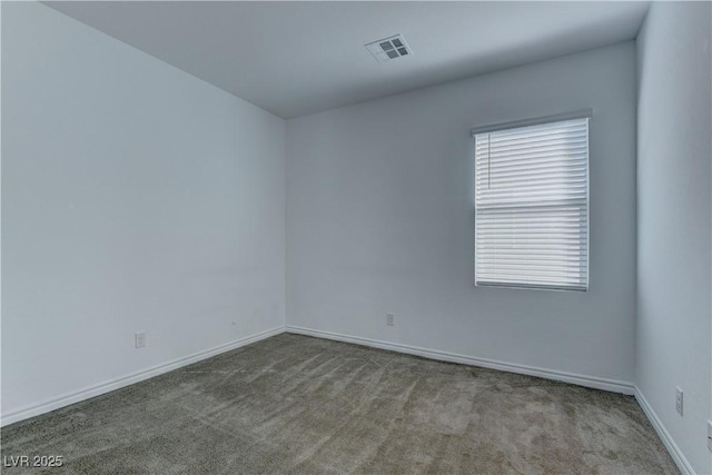 carpeted spare room featuring visible vents and baseboards