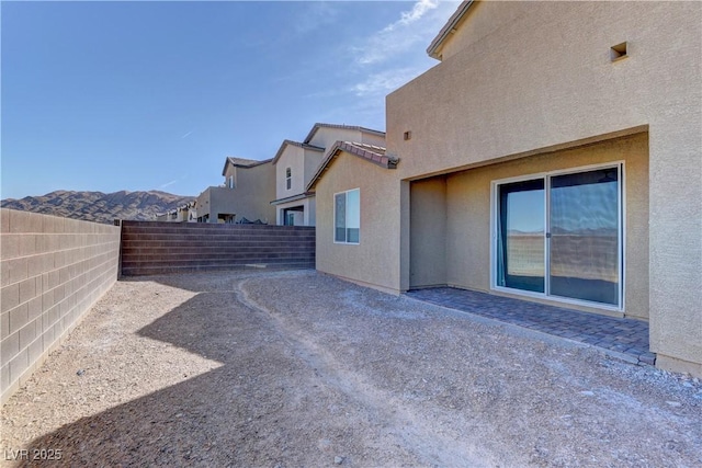 exterior space featuring a patio, a fenced backyard, and stucco siding