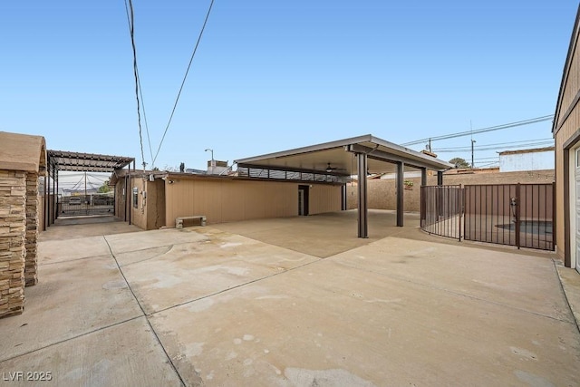 view of patio with driveway, fence, and a gate