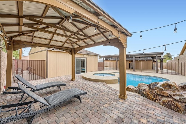 view of pool with an in ground hot tub, a fenced backyard, a patio area, and a gazebo