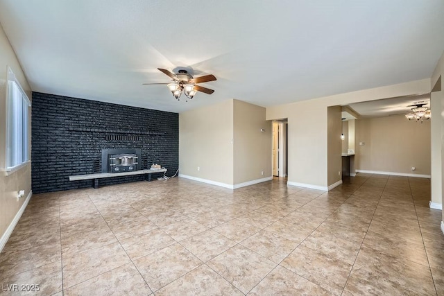 unfurnished living room featuring baseboards, a ceiling fan, and tile patterned floors