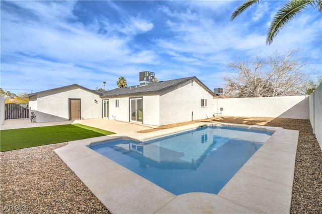 rear view of house with a fenced in pool, a patio, stucco siding, cooling unit, and a fenced backyard