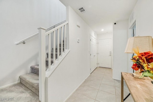 stairway with tile patterned flooring, visible vents, baseboards, and recessed lighting