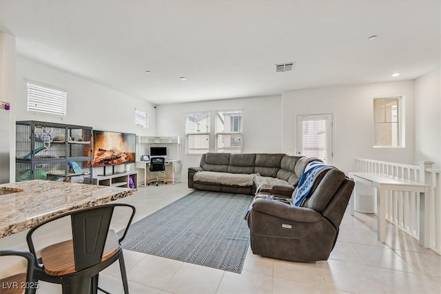 living room featuring light tile patterned flooring, visible vents, and recessed lighting