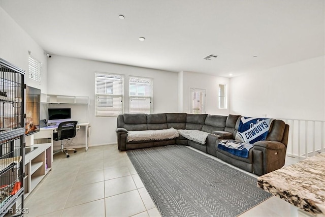 tiled living room featuring visible vents