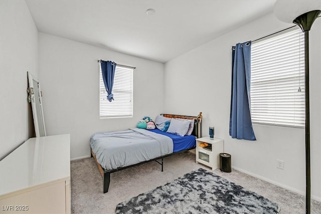 bedroom with carpet floors and baseboards