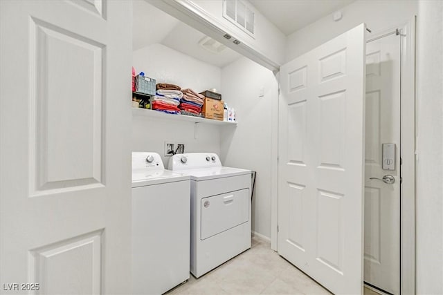 clothes washing area with laundry area, light tile patterned floors, visible vents, and independent washer and dryer