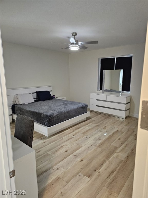 bedroom featuring a ceiling fan and wood finished floors