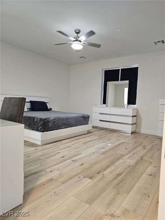 unfurnished bedroom with baseboards, wood finished floors, visible vents, and a ceiling fan