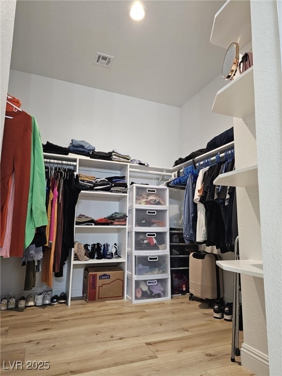 walk in closet featuring wood finished floors