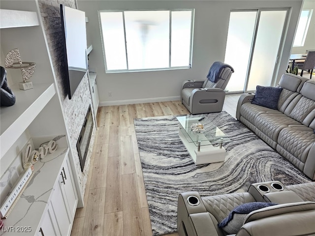 living room with light wood-style flooring and baseboards