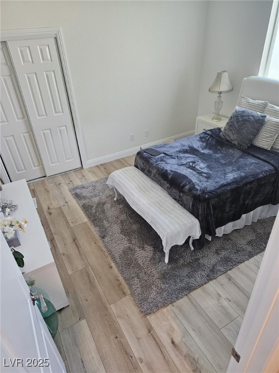 bedroom featuring baseboards and wood finished floors