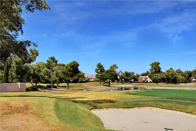 surrounding community featuring a yard and golf course view