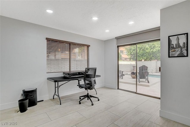 office space with recessed lighting, a textured ceiling, and baseboards