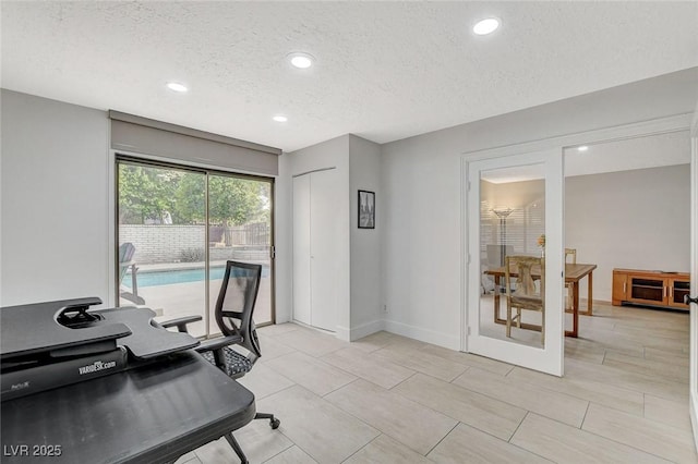 office area with a textured ceiling, baseboards, and recessed lighting