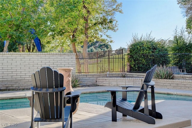 view of swimming pool with a patio area and a fenced backyard