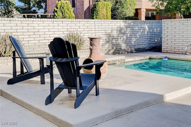 view of pool featuring a patio and a fenced backyard