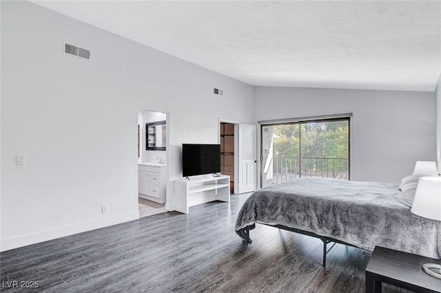 bedroom featuring lofted ceiling, access to outside, visible vents, and wood finished floors