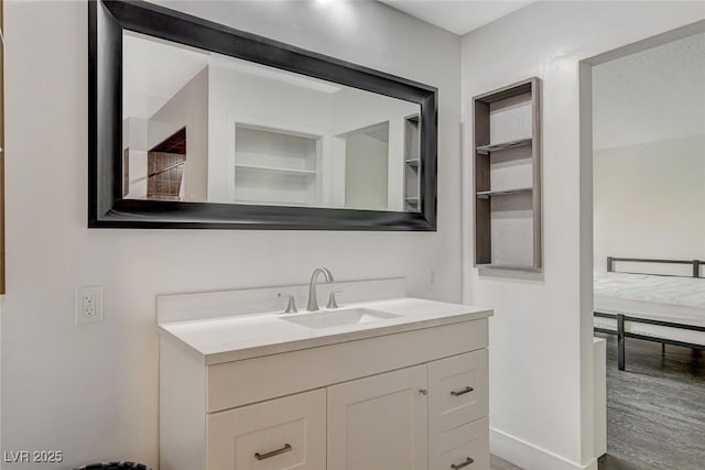 bathroom with baseboards and vanity