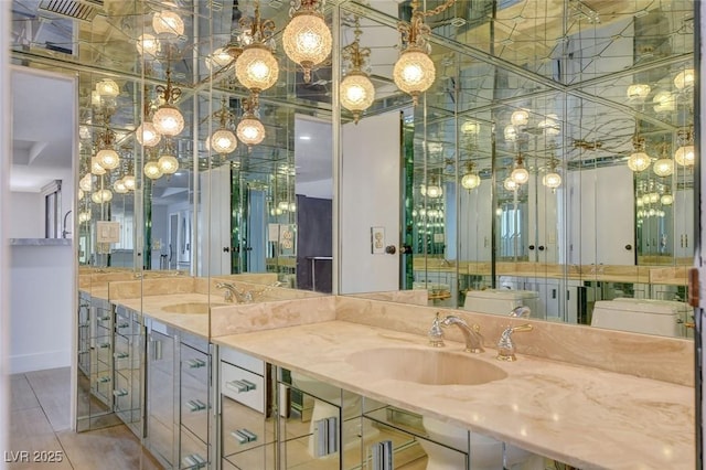 full bathroom featuring double vanity and a sink