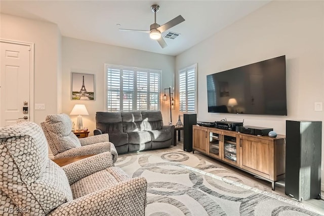 living room featuring ceiling fan and visible vents