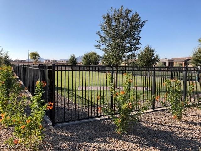 view of gate featuring a yard and fence