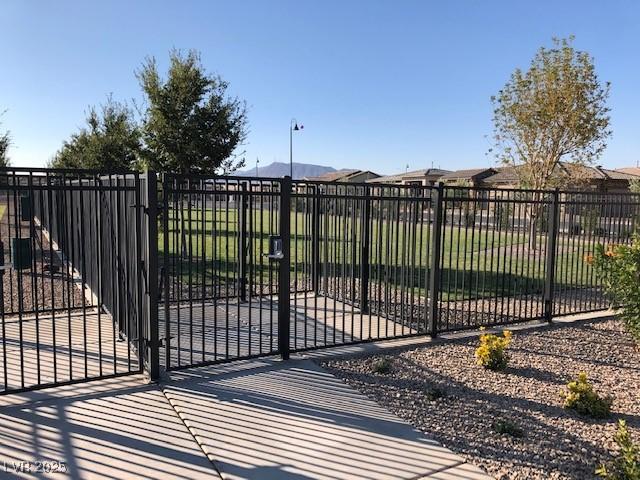 view of gate featuring fence and a mountain view