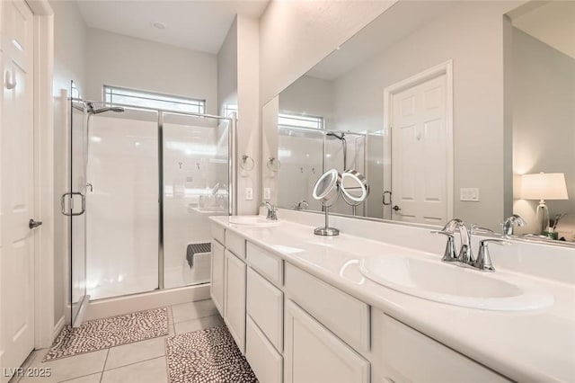 bathroom featuring tile patterned flooring, a sink, and a shower stall