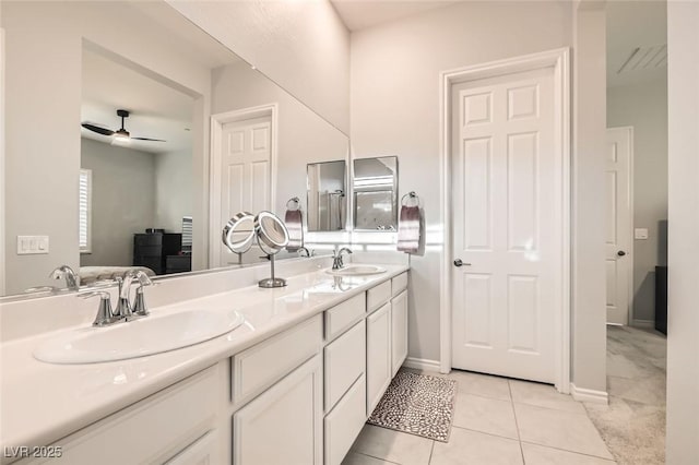 full bathroom with ceiling fan, double vanity, a sink, and tile patterned floors