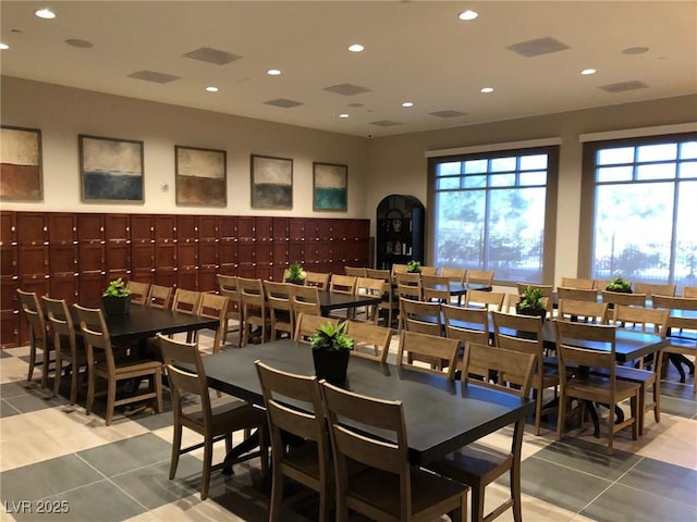 tiled dining room featuring recessed lighting