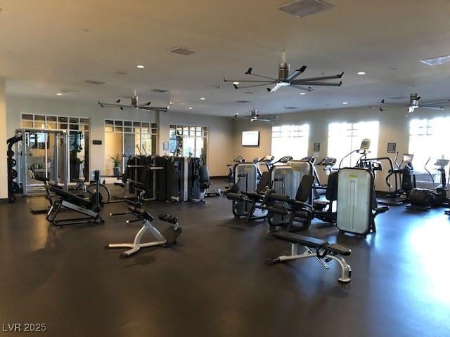 gym with ceiling fan and visible vents