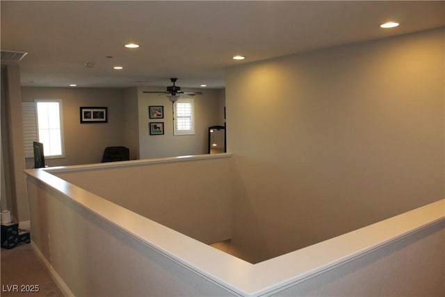 interior space with visible vents and a ceiling fan