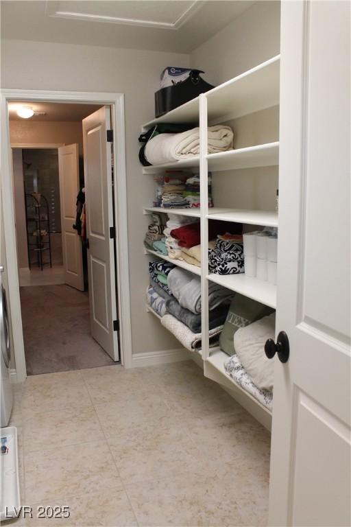 spacious closet featuring tile patterned flooring