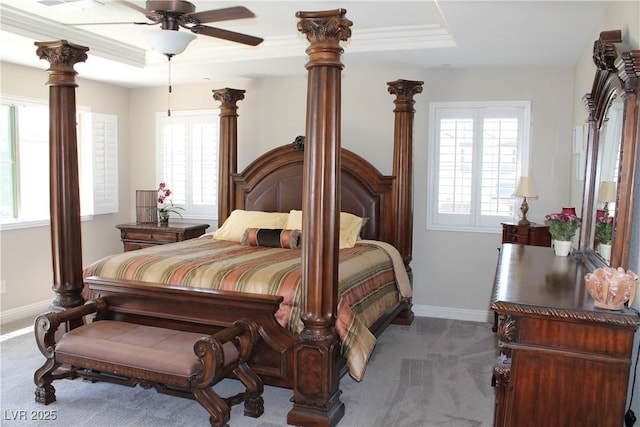 bedroom featuring carpet, a tray ceiling, and baseboards