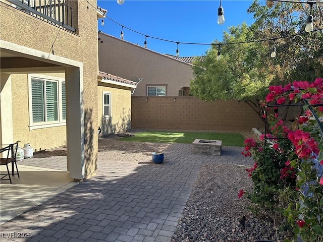 view of patio with an outdoor fire pit and fence private yard