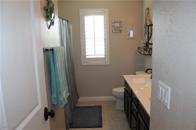 full bathroom featuring toilet, vanity, a shower with curtain, baseboards, and tile patterned floors