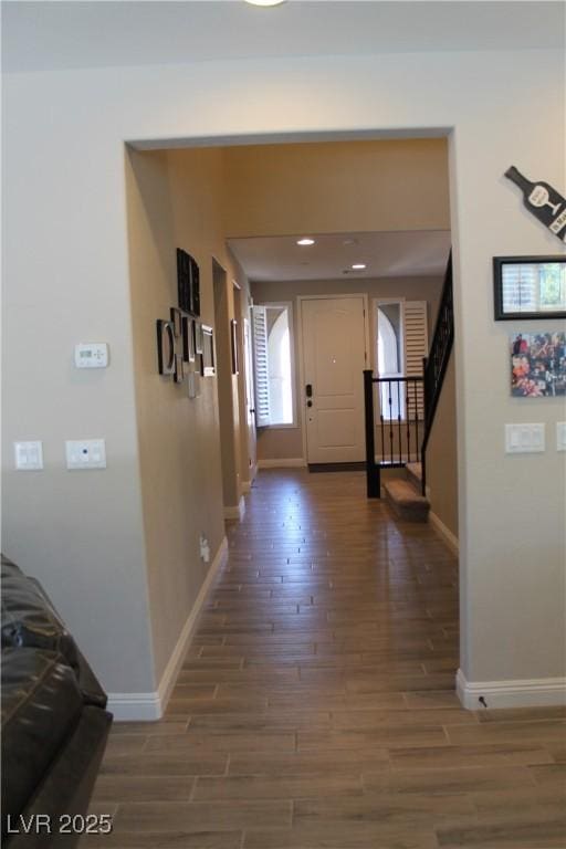 interior space featuring baseboards, stairway, wood finished floors, and recessed lighting