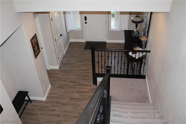 interior space featuring baseboards, stairway, and wood tiled floor