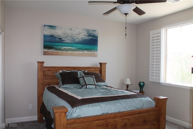 carpeted bedroom featuring ceiling fan, visible vents, and baseboards