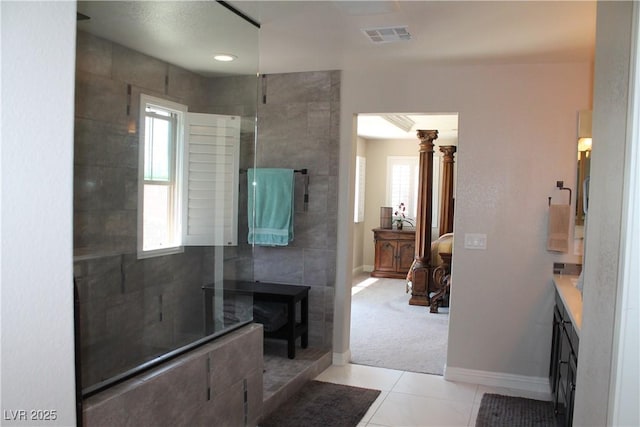 bathroom featuring a walk in shower, plenty of natural light, decorative columns, and tile patterned floors