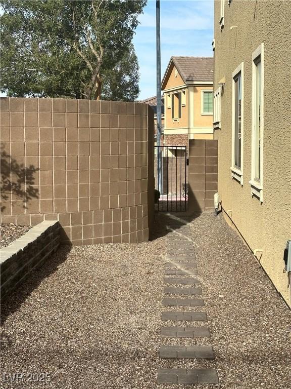 view of yard featuring fence and a gate